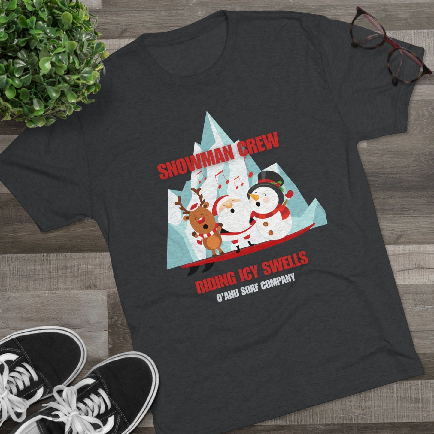 O'ahu Surf Company Snowman Crew Riding Icy Swells T-shirt. Christmas tee featuring a snowman surfing.